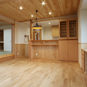 リビング02： キッチンの流し台はリビングから見えないようにカウンターの高さを少し高く設定しています。天井は宮城県のくりこま杉、壁は珪藻土、床はなら無垢フローリングです。