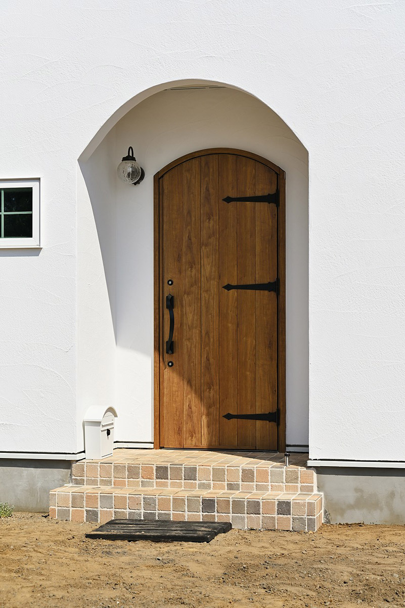 玄関ドアはアーチ形で柔らかい印象に。