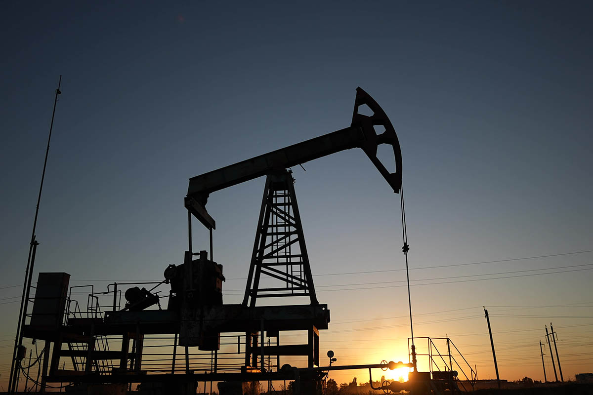 oil production. silhouette oil and gas production rig at sunset glare. oilfield business a extraction concept. oil extraction pump. Oil lifestyle pump rig