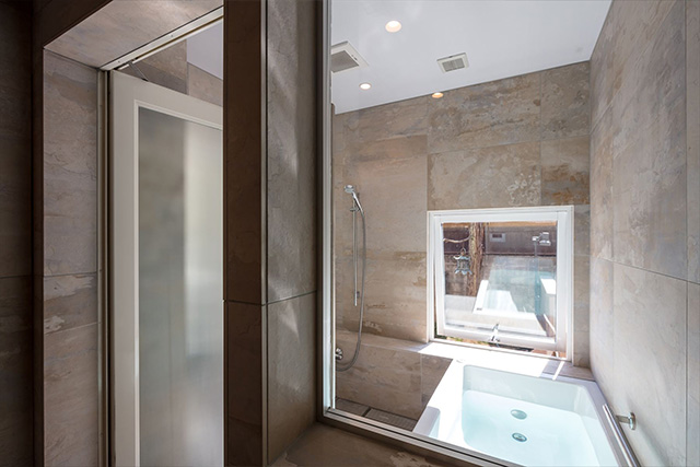 パウダールームとお揃いのタイル貼りのバスルーム