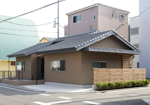 平瓦の屋根と塗り壁の「家らしい」シンプルな外観。ポイントに使った木が優しい雰囲気を与えています